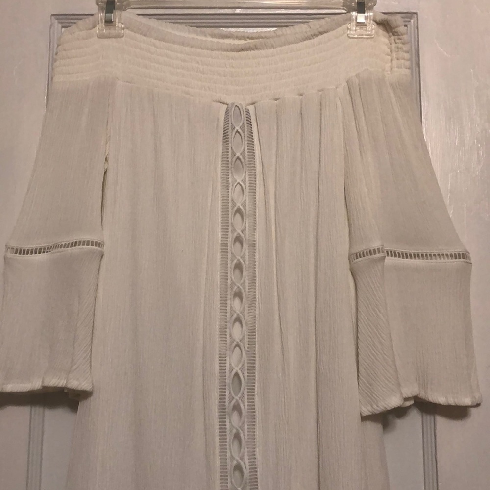 White dress with geometrical lined cut outs